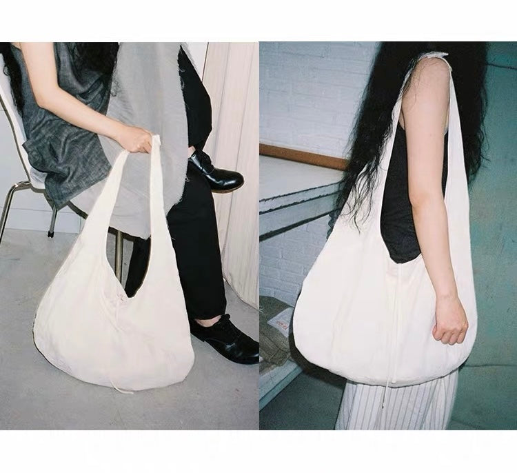 <Another i.> Adjustable Egg-Shaped Crossbody Bag