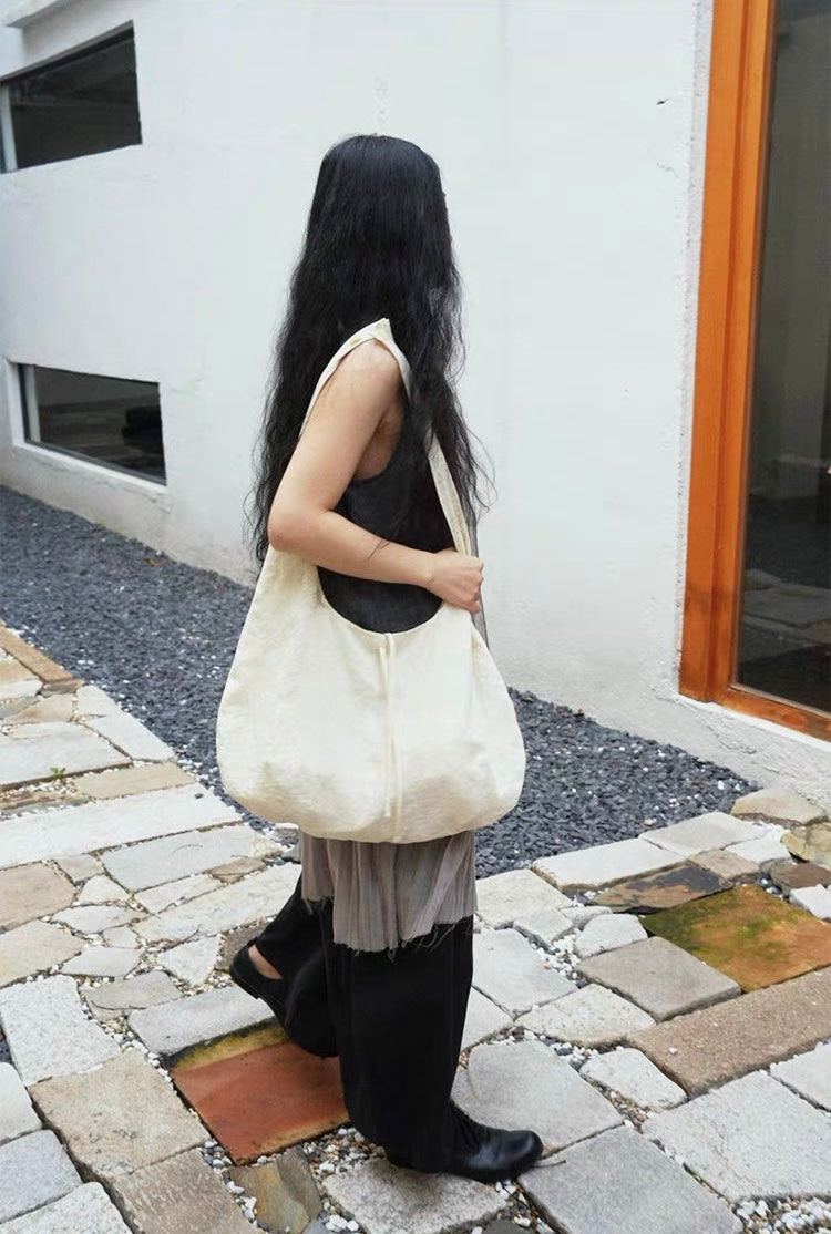 <Another i.> Adjustable Egg-Shaped Crossbody Bag